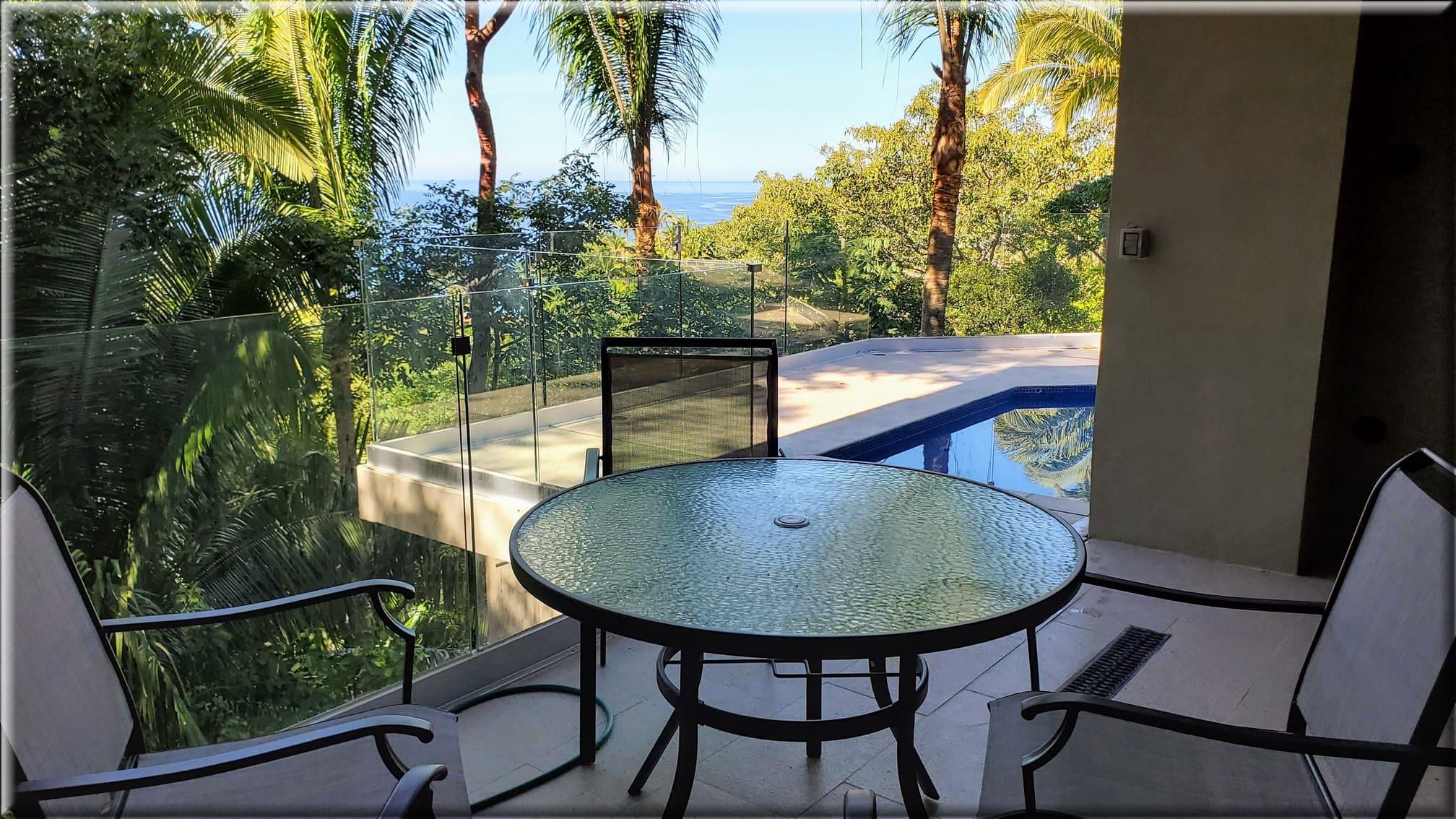 Private veranda with jungle and partial ocean views. Private veranda with jungle and partial ocean views.